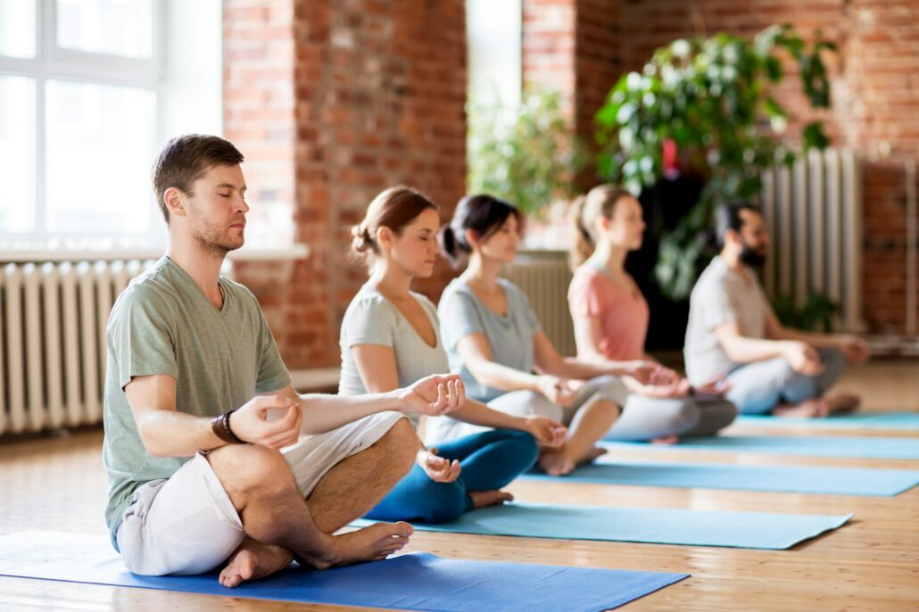 group of people making yoga exercises at studio